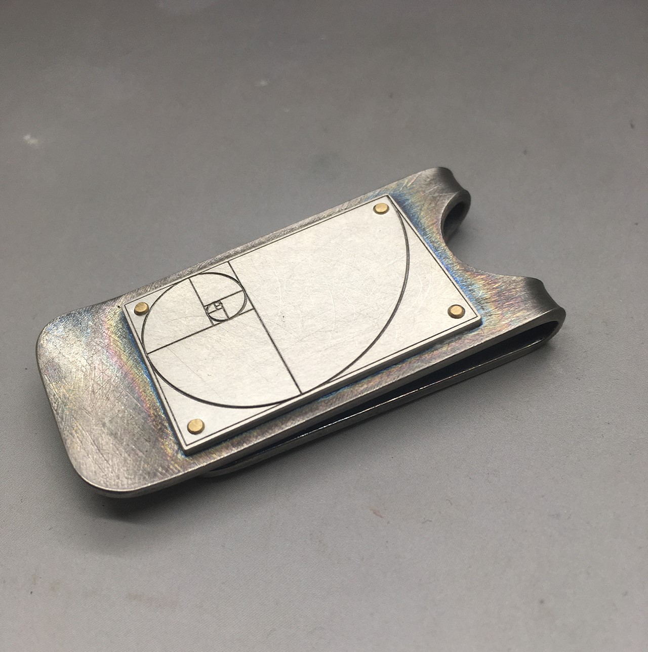 money holders in titanium, silver and yellow gold